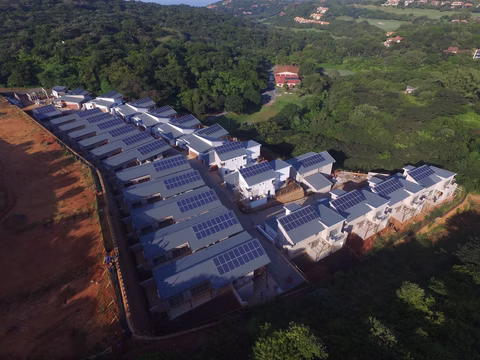 Aerial view of a housing development with rooftop solar panels
